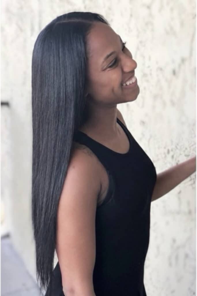 pretty black girl smiling as she leave salon with a tradition sew in