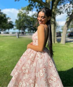 Woman with long straight traditional sew in wearing a pink lace dress outdoors • Title: Glamorous Straight Traditional Se